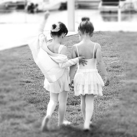 Filler image of two young girls dressed in ballet outfits.